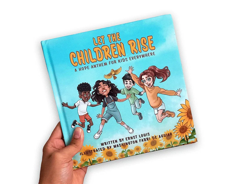 A hand holding the hardcover picture book Let the Children Rise
